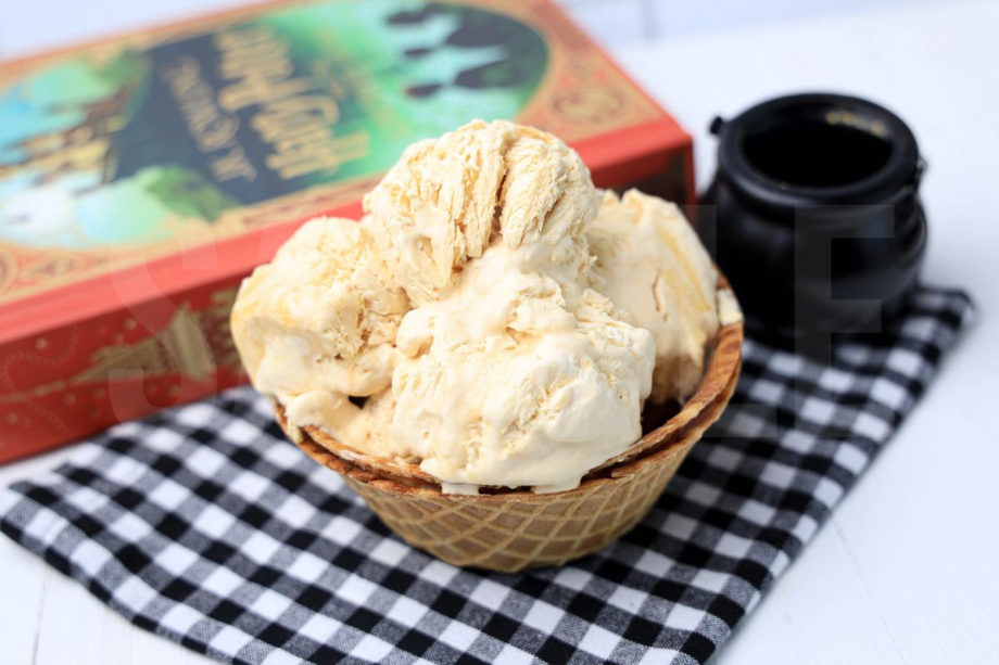 The Harry Potter Butterbeer Ice Cream comes in a waffle bowl with plaid napkin on a white wood backdrop.