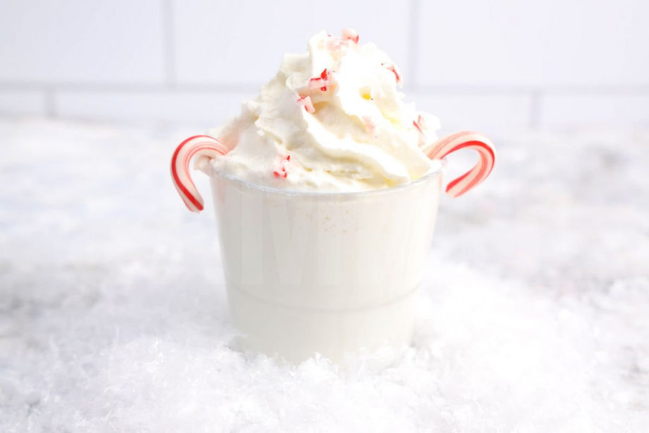 The Boozy Snowflake comes in a clear glass on a marble wood backdrop.