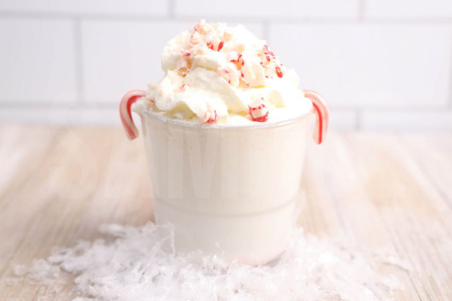 The Boozy Snowflake comes in a clear glass on a rustic wood backdrop.