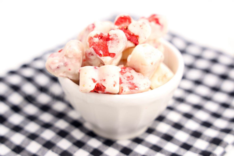 The Strawberry Fudge Hearts comes in a white bowl with a plaid napkin on a white wood backdrop.