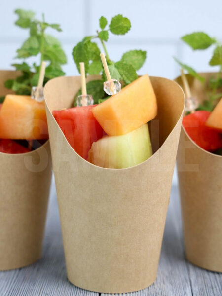 The Melon Fruit Cups comes in a brown fry cup with gray wood backdrop.