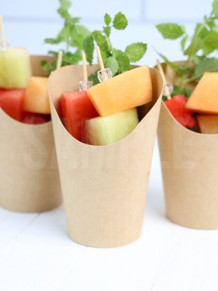 The Melon Fruit Cups comes in a brown fry cup with white wood backdrop.