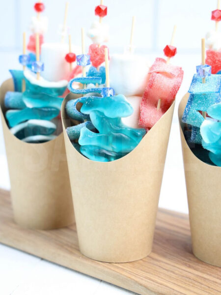 The Shark Candy Cups comes in a brown fry cup with white wood backdrop.