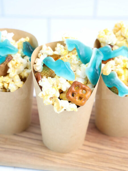 The Shark Snack Cups comes in a brown fry cup with white wood backdrop.