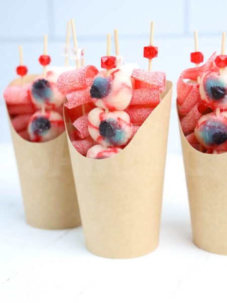 The Eyeball Candy Cups comes in a brown fry cup with white wood backdrop.